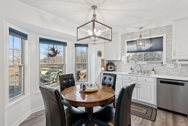 15027 Madison Pike, Morning View, KY 41063 - dining area with a chandelier, plenty of natural light, light wood-style floors, and baseboards
