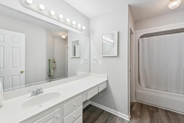 15027 Madison Pike, Morning View, KY 41063 - full bath featuring wood finished floors, vanity, shower / bath combination with curtain, baseboards, and a textured ceiling