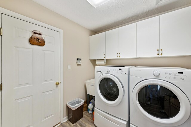 15027 Madison Pike, Morning View, KY 41063 - laundry area with cabinet space, separate washer and dryer, and light wood-style flooring