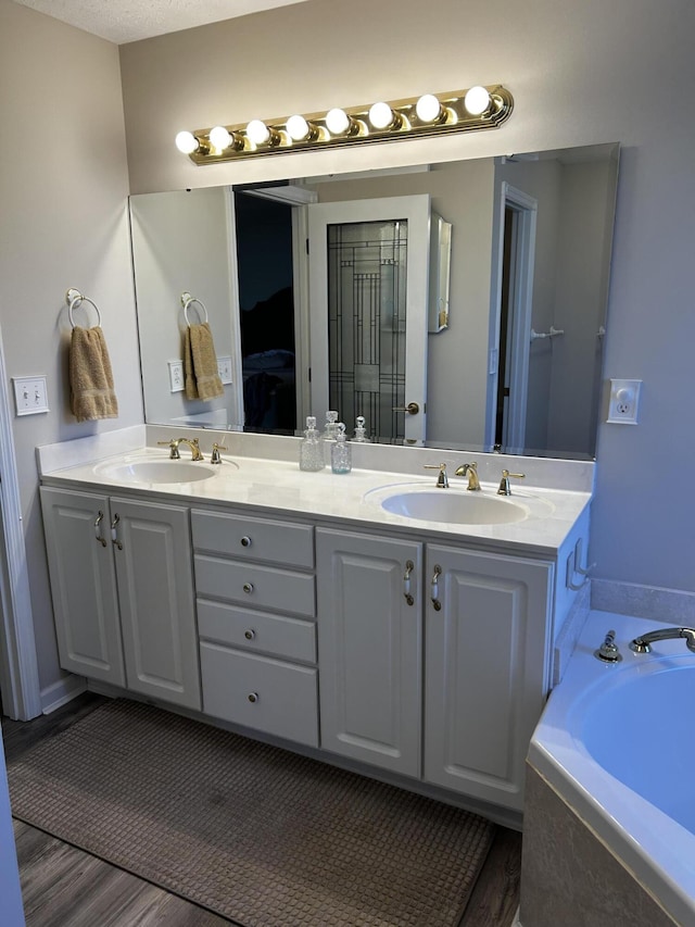 15027 Madison Pike, Morning View, KY 41063 - full bathroom featuring double vanity, wood finished floors, a bath, and ensuite bathroom