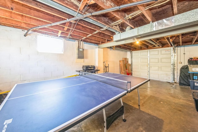 rec room with concrete flooring and electric panel