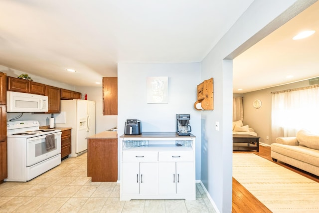 kitchen featuring white appliances and white cabinets