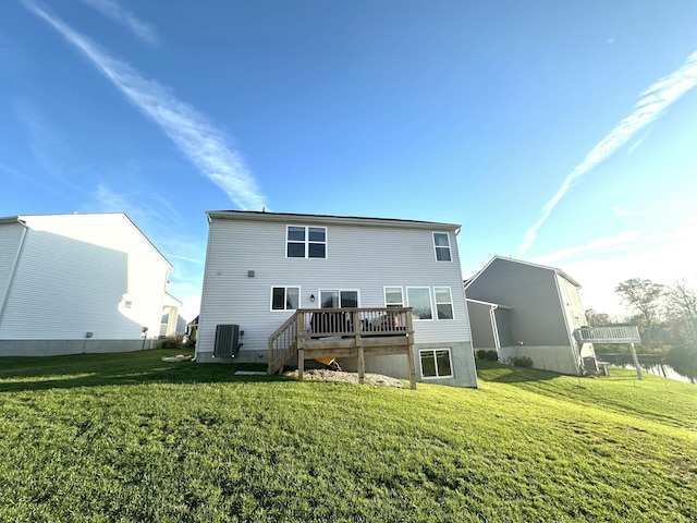 back of property with a yard, central AC unit, and a wooden deck