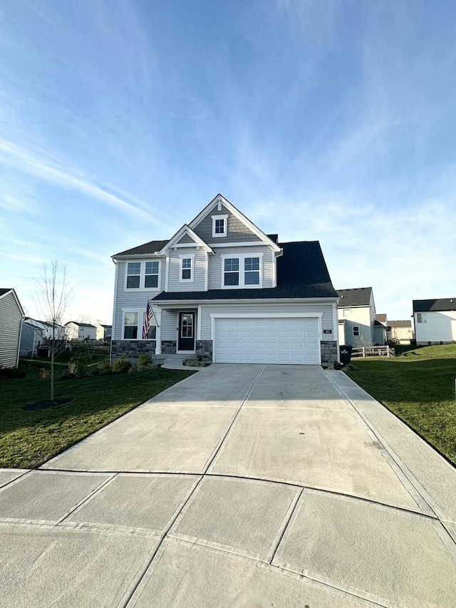 view of front of house with a garage, stone siding, driveway, and a front yard