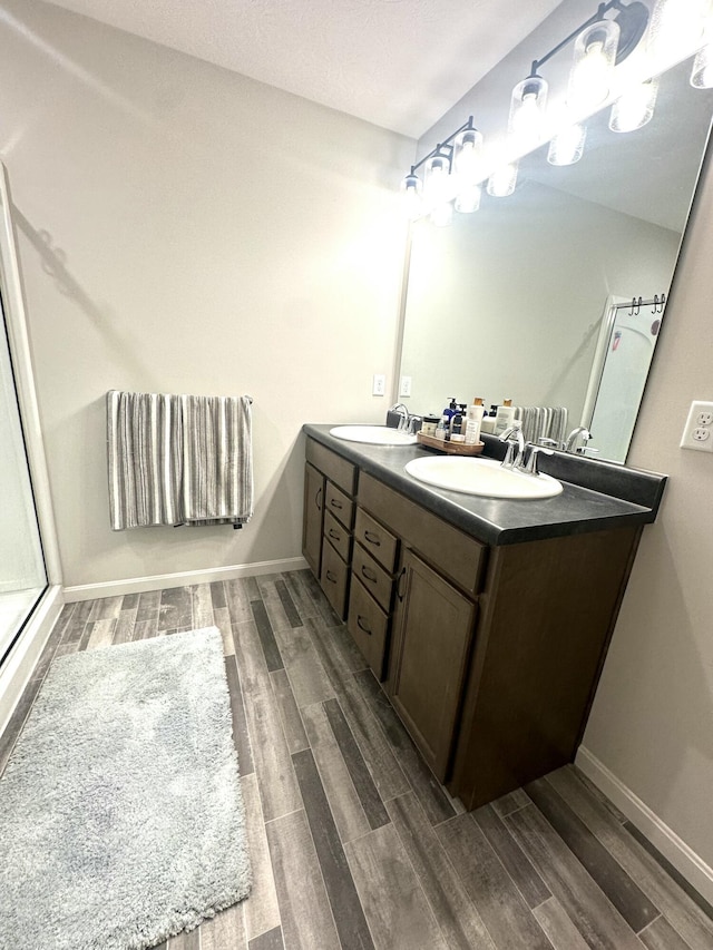 bathroom featuring vanity and an enclosed shower