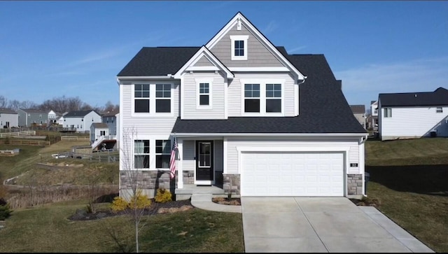 view of front of home with a shingled roof, concrete driveway, stone siding, and a front lawn