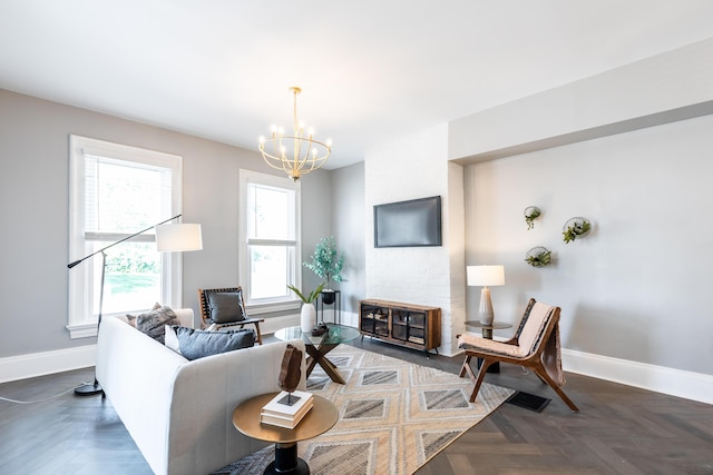 living room featuring dark parquet flooring and a chandelier