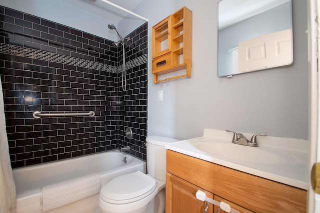 full bathroom featuring tiled shower / bath, vanity, and toilet