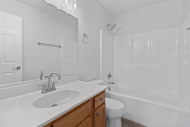 full bathroom with vanity, toilet, a textured ceiling, and shower / bath combination