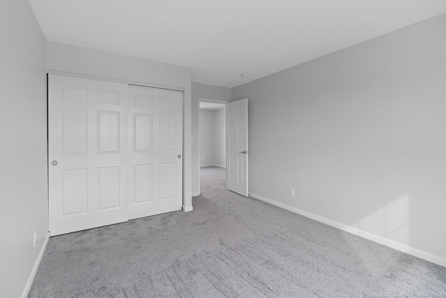 unfurnished bedroom with a closet and carpet