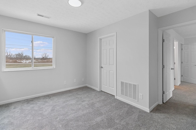 unfurnished bedroom with carpet and a textured ceiling