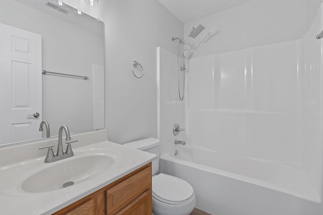 full bathroom featuring vanity, bathtub / shower combination, a textured ceiling, and toilet