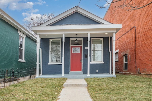 view of front of house with covered porch and a front yard