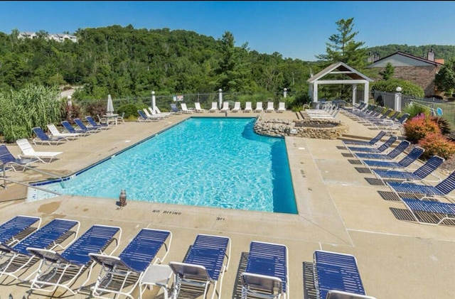 view of swimming pool featuring a gazebo and a patio area