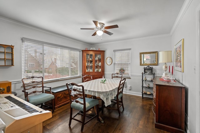 dining room with crown molding, ceiling fan, and dark hardwood / wood-style flooring