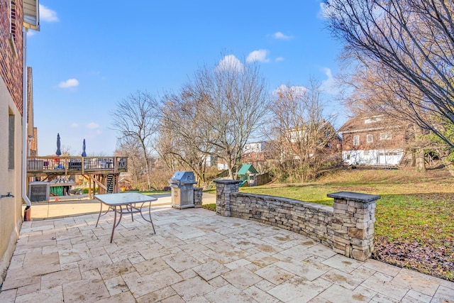 view of patio with a wooden deck and grilling area