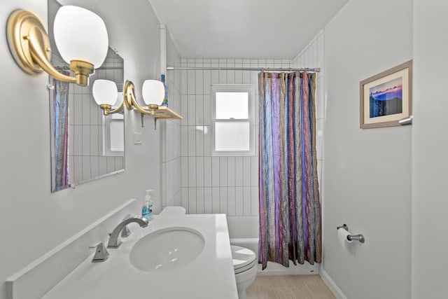 full bathroom with sink, shower / tub combo, tile patterned floors, and toilet