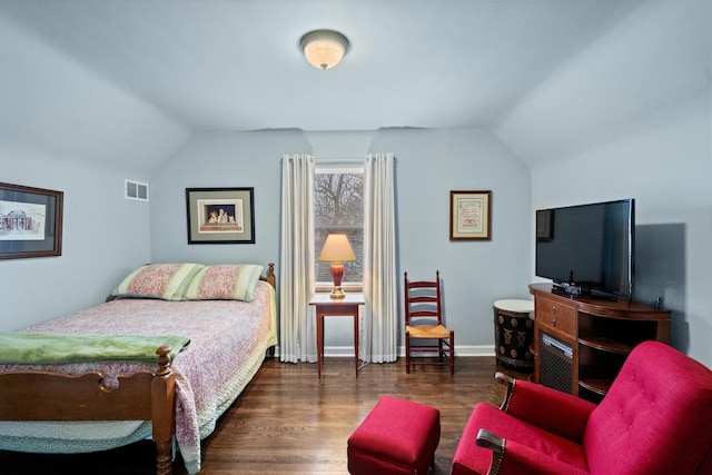 bedroom with vaulted ceiling and dark hardwood / wood-style floors