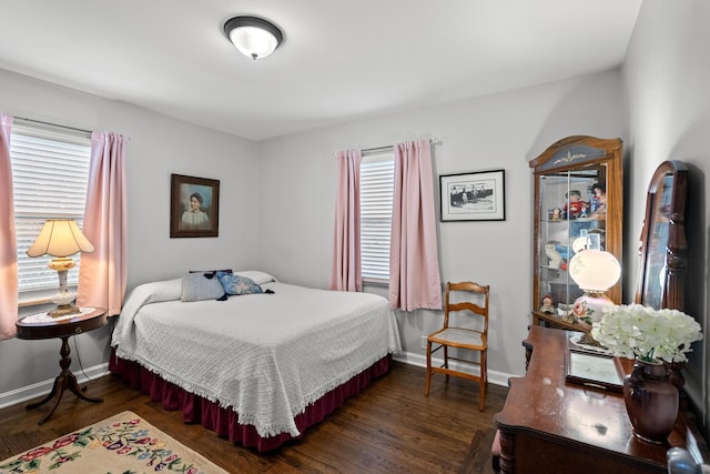 bedroom with dark wood-type flooring