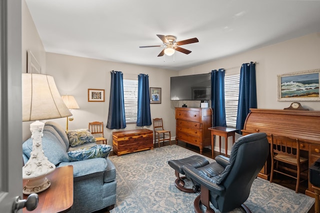 living room featuring a wealth of natural light and ceiling fan