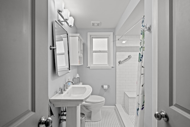 bathroom with a shower with shower curtain and toilet