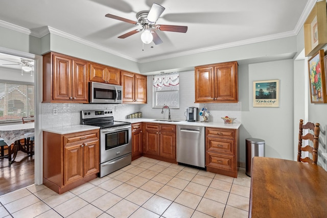 kitchen featuring sink, crown molding, appliances with stainless steel finishes, ceiling fan, and backsplash