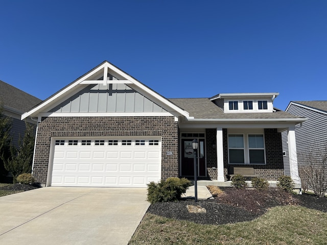 view of front of house with a porch, an attached garage, brick siding, concrete driveway, and board and batten siding