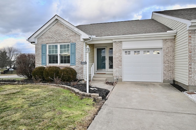 ranch-style house featuring a garage and a front lawn