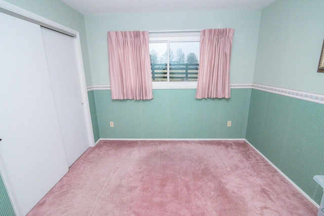 unfurnished bedroom with carpet floors and a closet