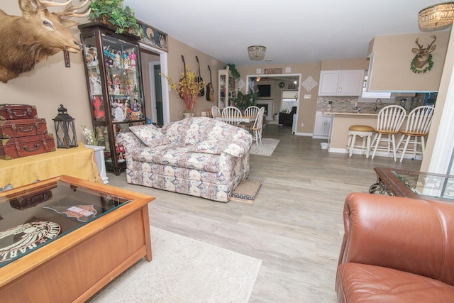 living room with sink and light hardwood / wood-style flooring