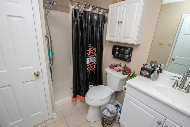 bathroom with vanity, toilet, curtained shower, and tile patterned flooring