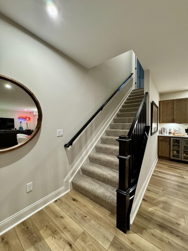 1516 Brumfield Ct, Union, KY 41091 - stairway with beverage cooler, wood finished floors, baseboards, a bar, and recessed lighting