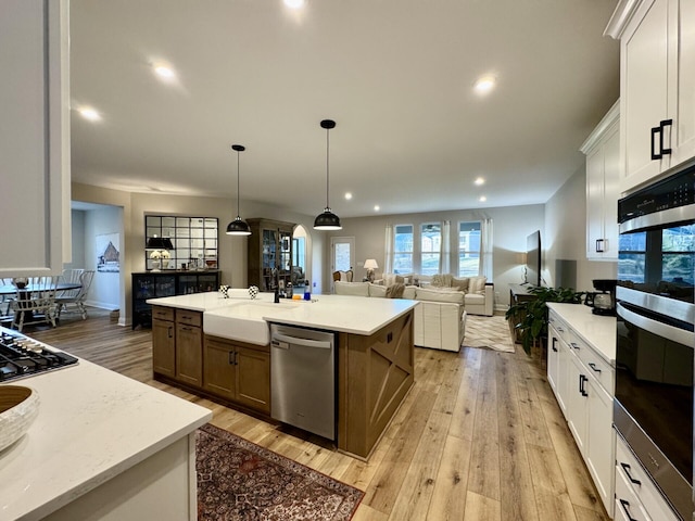 1516 Brumfield Ct, Union, KY 41091 - kitchen featuring appliances with stainless steel finishes, white cabinetry, light wood-style flooring, a kitchen island with sink, and recessed lighting
