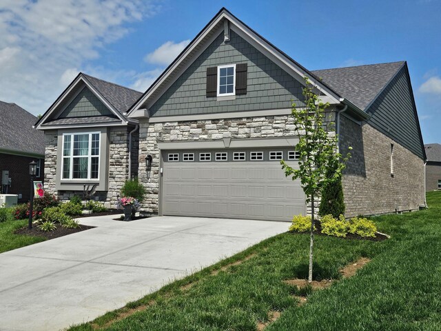 1516 Brumfield Ct, Union, KY 41091 - craftsman house with concrete driveway, stone siding, a garage, and a front lawn