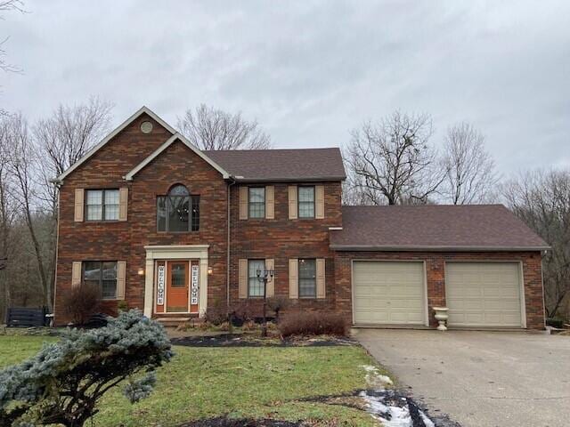 view of front of house featuring a garage and a front lawn