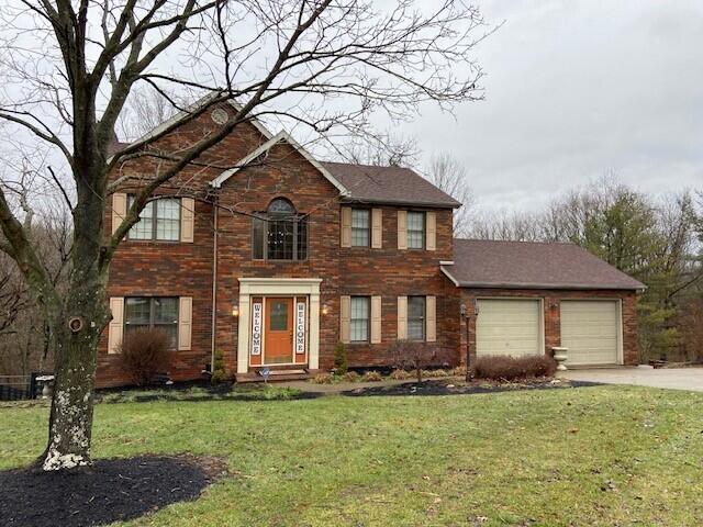 view of front facade with a garage and a front lawn