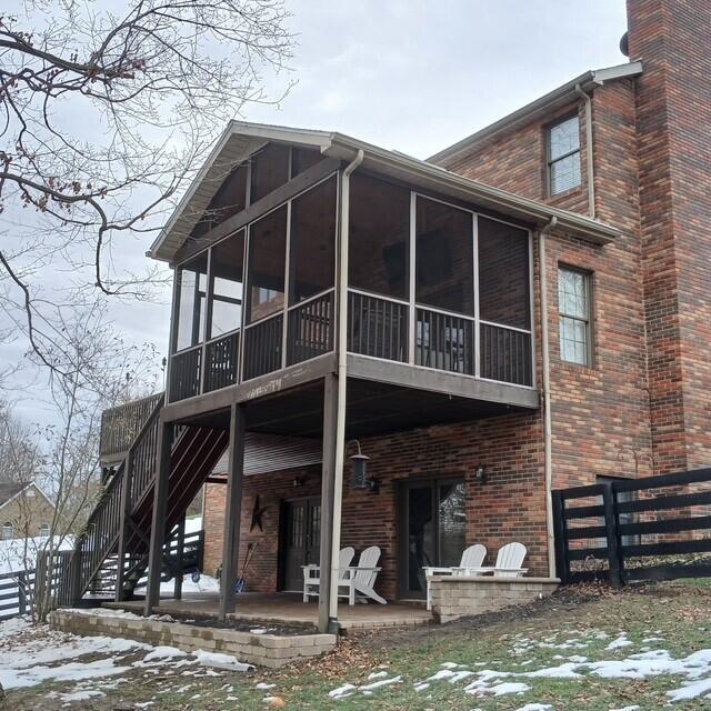 view of snowy exterior with a patio