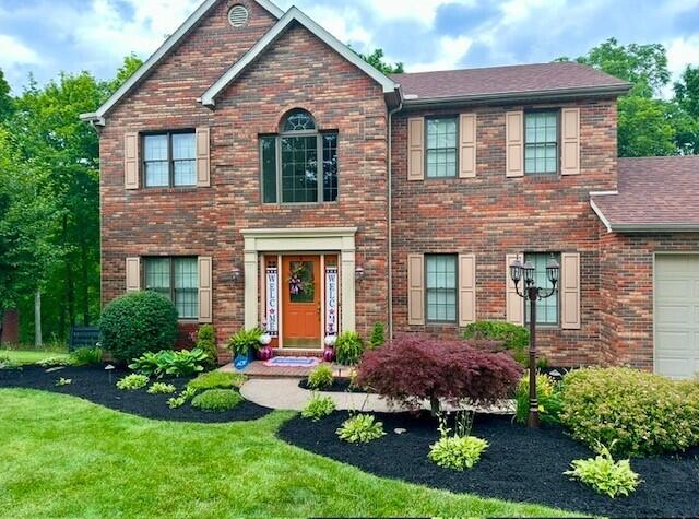 view of front facade with a garage and a front lawn