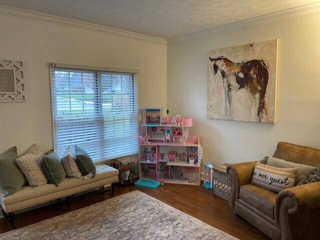 sitting room featuring dark hardwood / wood-style flooring and ornamental molding