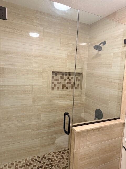 bathroom with a shower with door