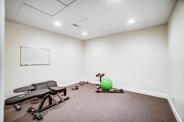 workout room with carpet flooring and a paneled ceiling