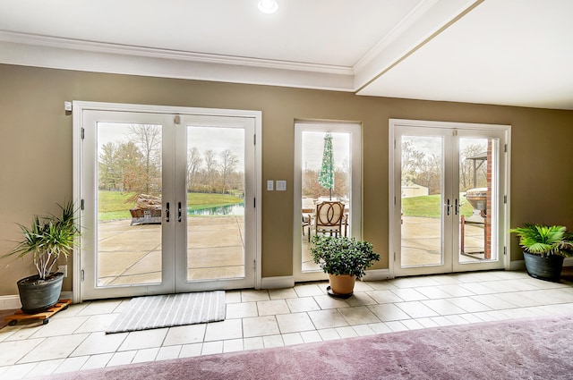 doorway to outside with light carpet, crown molding, and french doors