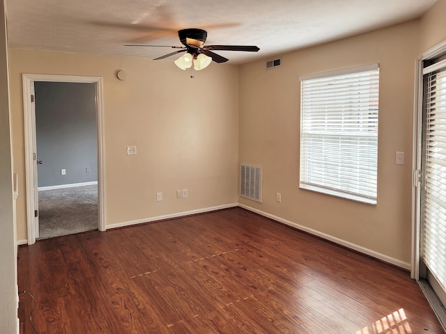 unfurnished bedroom with dark wood-type flooring and ceiling fan