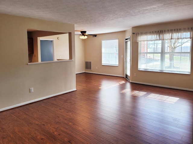 empty room featuring ceiling fan, wood-type flooring, and a textured ceiling