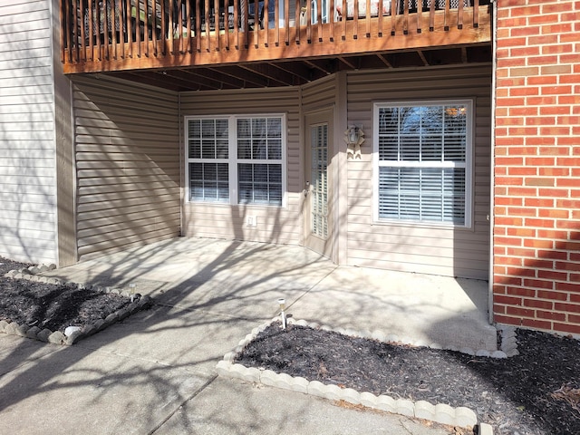 view of exterior entry featuring a patio