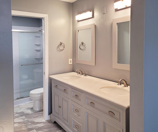 bathroom featuring walk in shower, vanity, and toilet