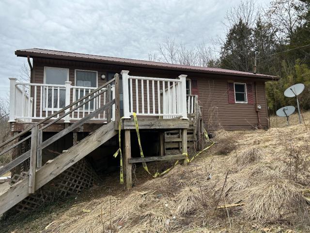 rear view of property featuring a deck