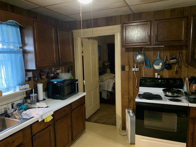 336 Roland Ave, Owenton, KY 40359 - kitchen featuring light countertops, dark brown cabinets, a drop ceiling, and black appliances
