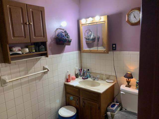 336 Roland Ave, Owenton, KY 40359 - bathroom featuring a wainscoted wall, vanity, toilet, and tile walls