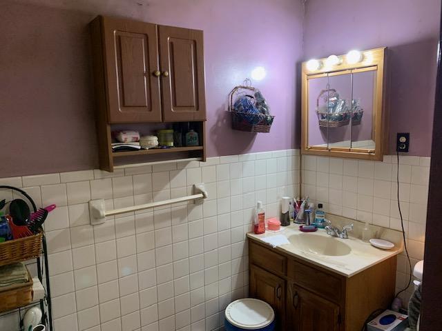 336 Roland Ave, Owenton, KY 40359 - bathroom featuring tile walls, wainscoting, and vanity